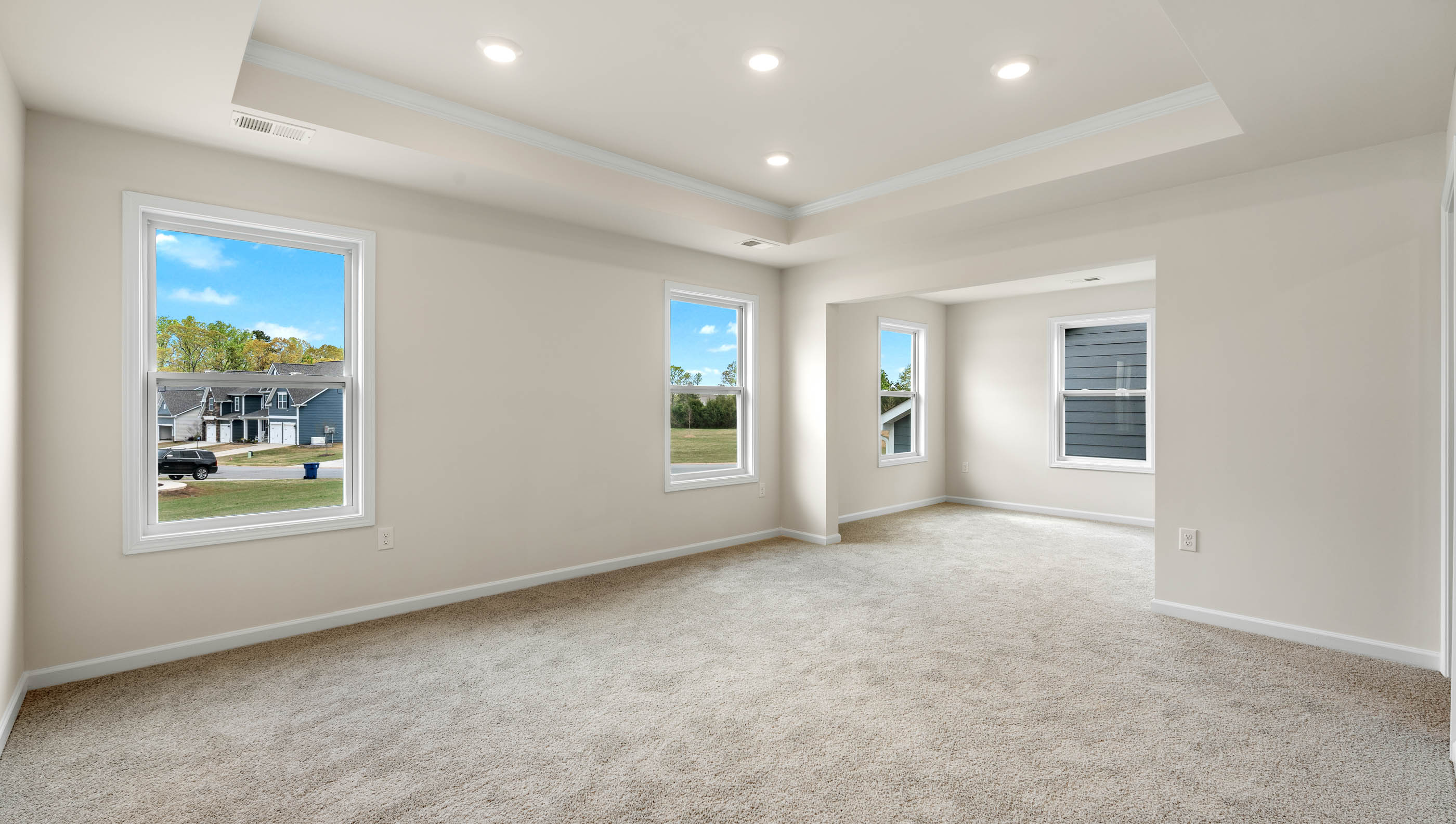 Bedroom with carpet and windows.