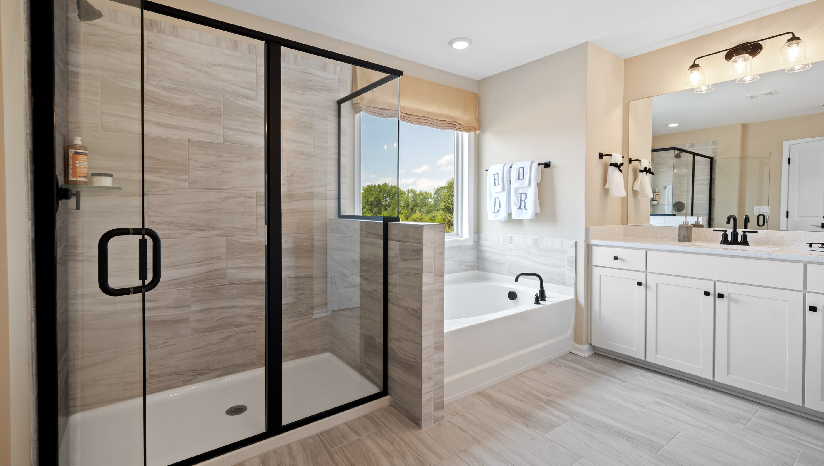 Bathroom  with tub, double vanity and walk in shower.