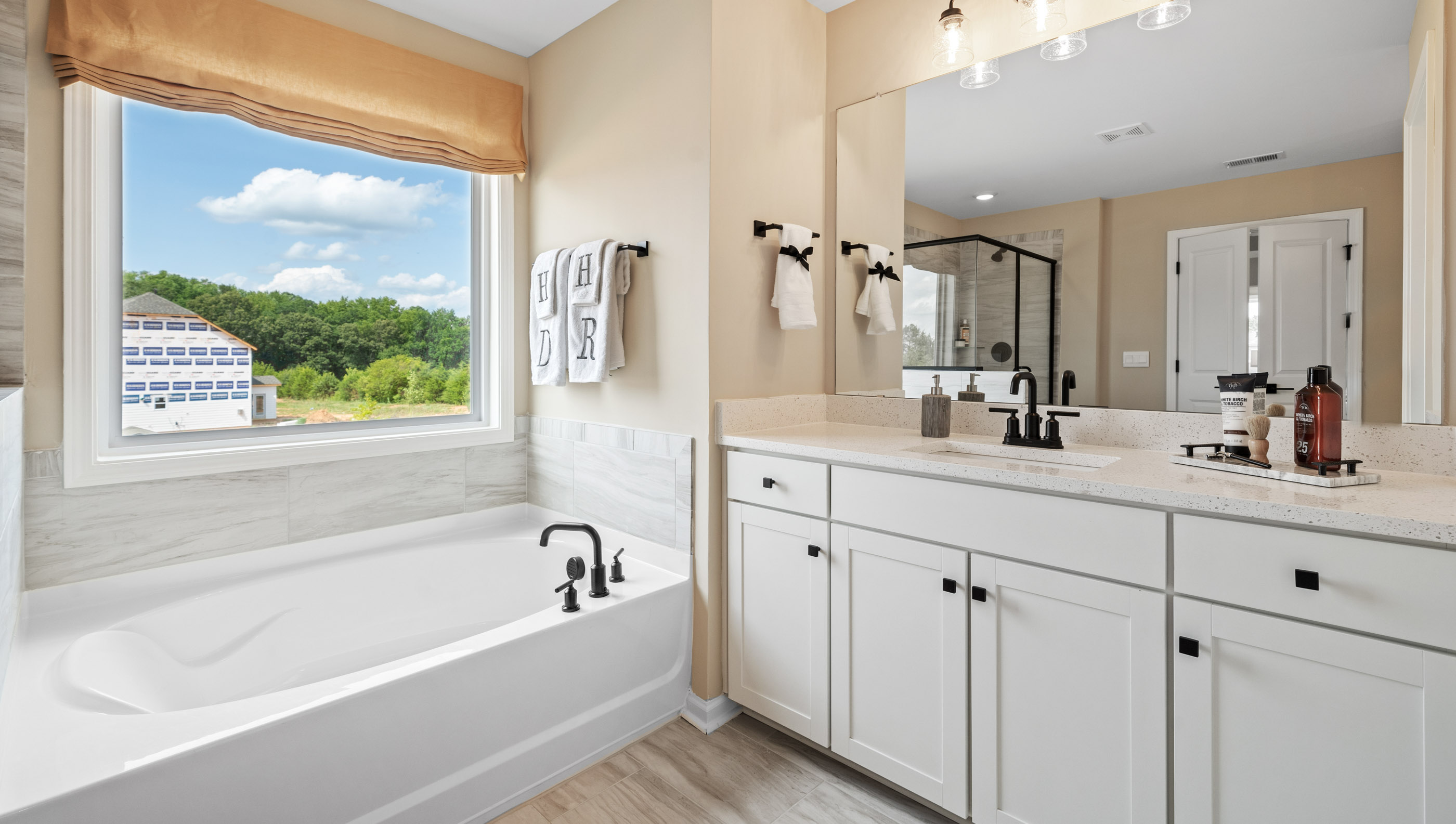 Bathroom  with tub, double vanity and walk in shower.