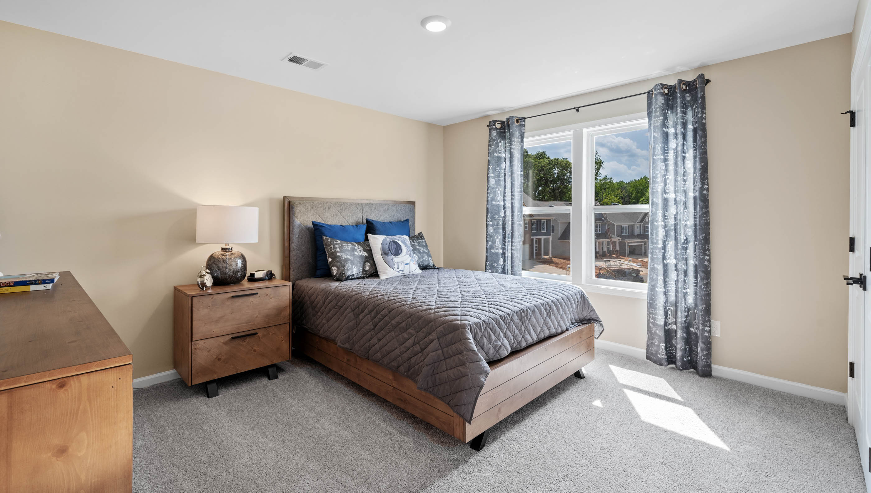 Bedroom with carpet and windows.