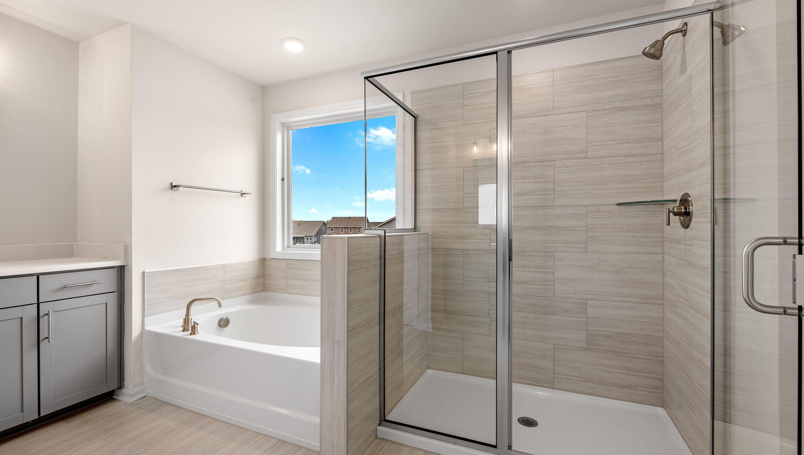 Bathroom with walk in shower with tub.
