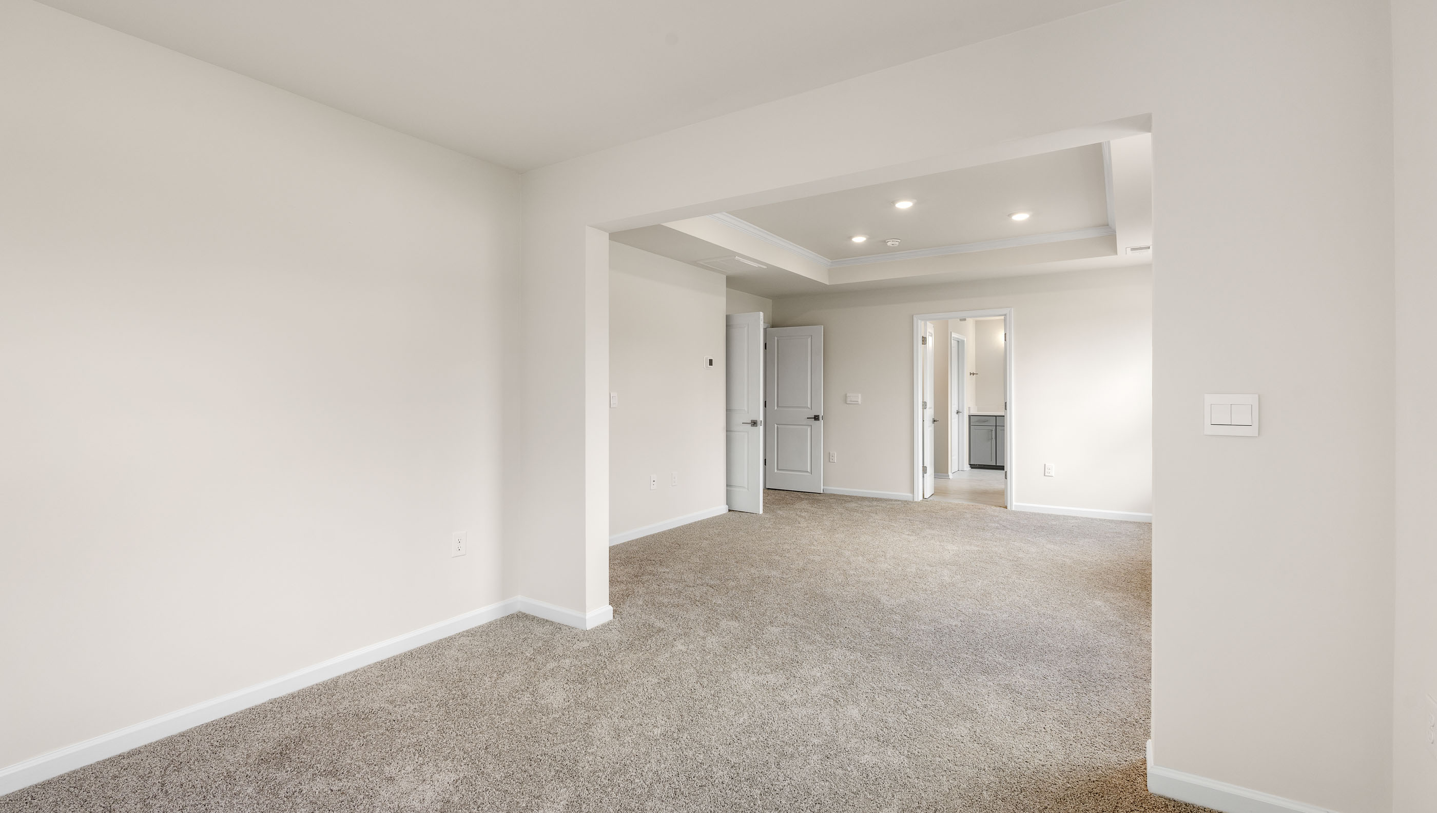 Bedroom with carpet and windows.