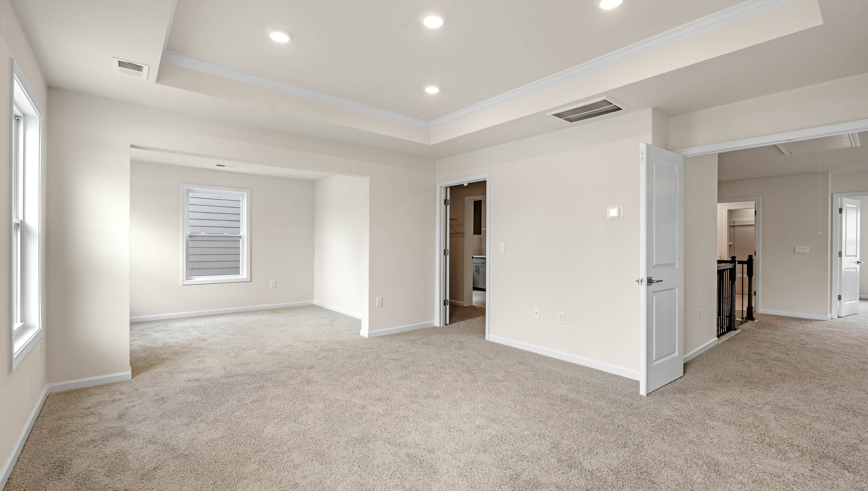 Bedroom with carpet and windows.