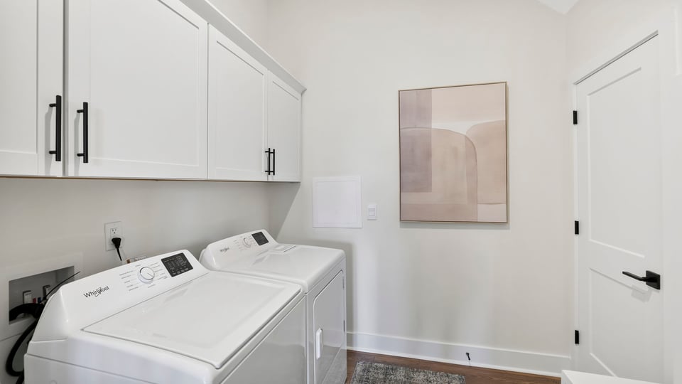 Laundry room with hanging storage racks.