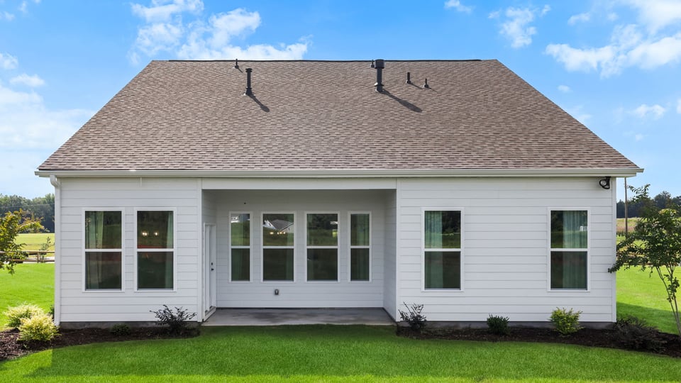 Back exterior of home with large backyard.