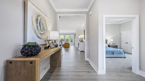 Entry way into home with view of bedroom.