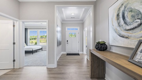 Entry way into home with view of bedroom.
