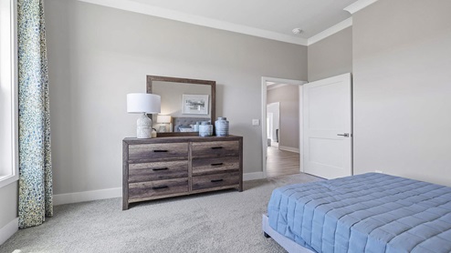 Bedroom with carpet and windows.