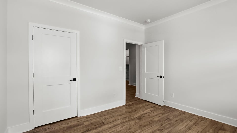 Bedroom with carpet and window.