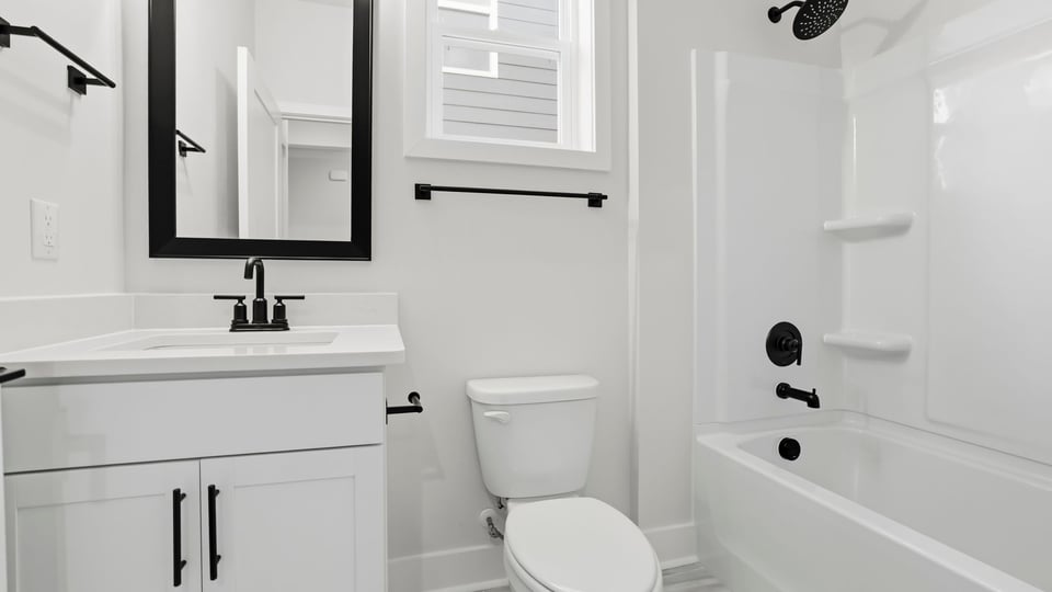 Bathroom with single vanity sink and bathub.
