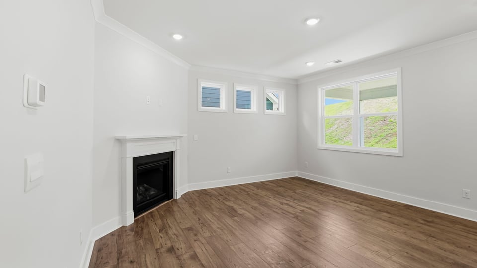 Family room with fireplace and window.