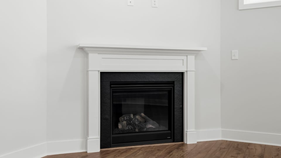 Family room with fireplace and window.