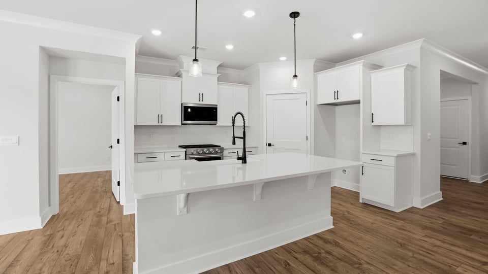 Kitchen and island with quartz countertops.
