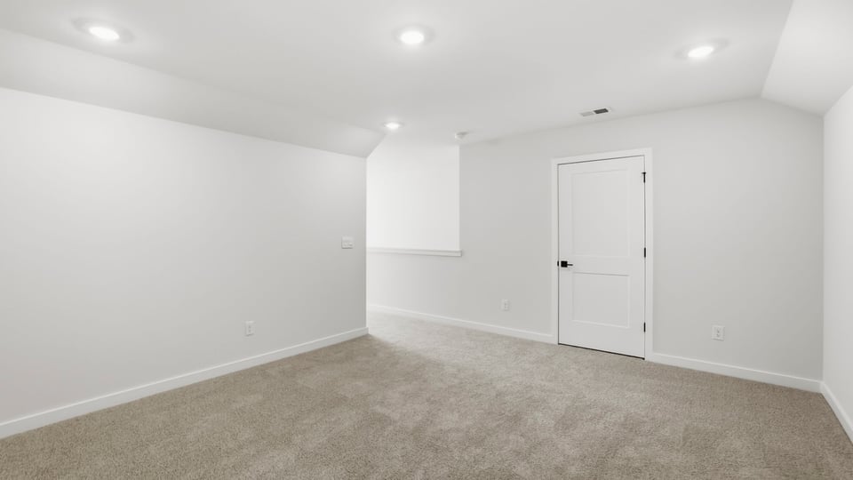 Bedroom with carpet upstairs.