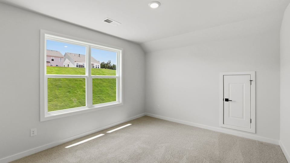 Bedroom with carpet and window.