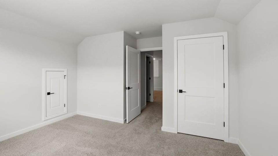 Bedroom with carpet and window.