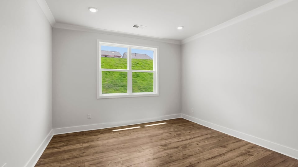 Bedroom with carpet and window.