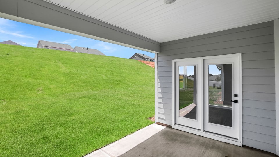 Back exterior of home with patio.