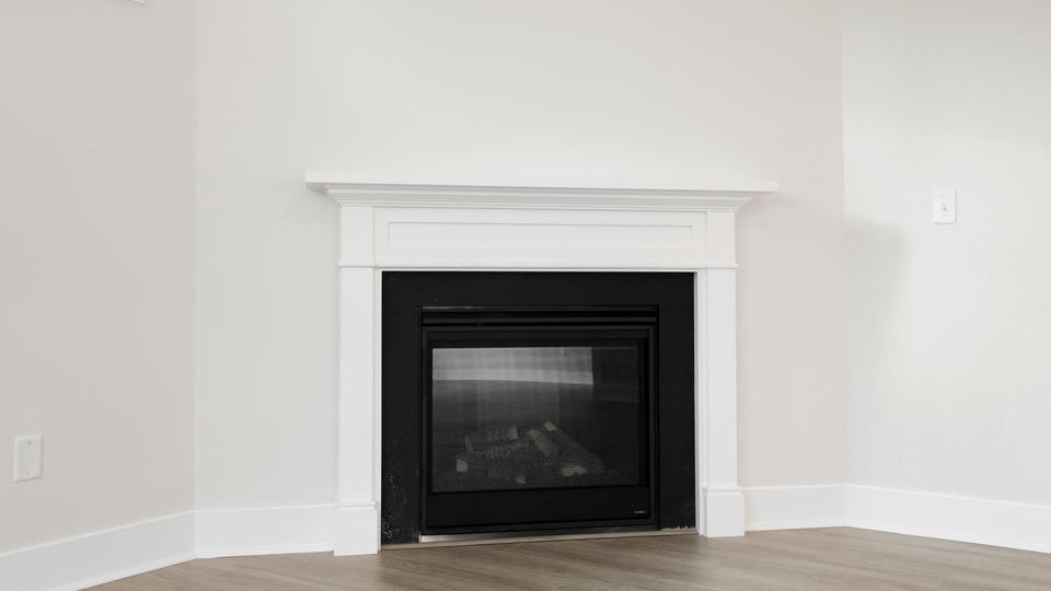 Living room with windows and fireplace.