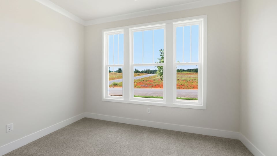 Bedroom with carpet and windows.