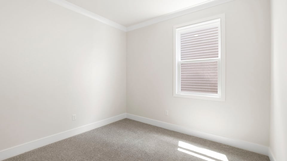 Bedroom with carpet and windows.