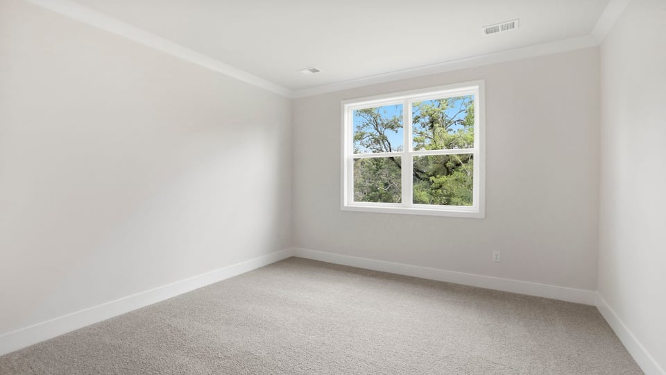 Bedroom with carpet and windows.