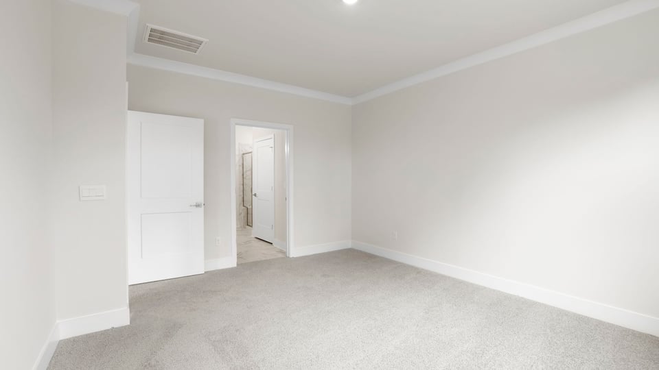 Bedroom with carpet and windows.