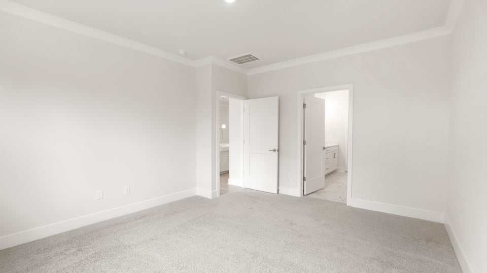 Bedroom with carpet and windows.