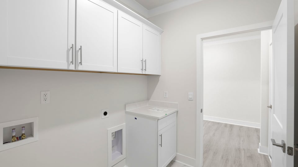 Laundry room with cabinets.
