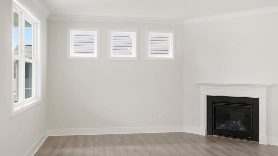 Living room with windows and fireplace.