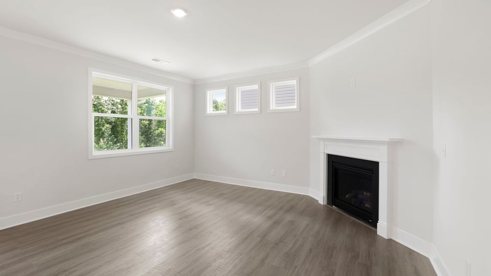 Living room with windows and fireplace.