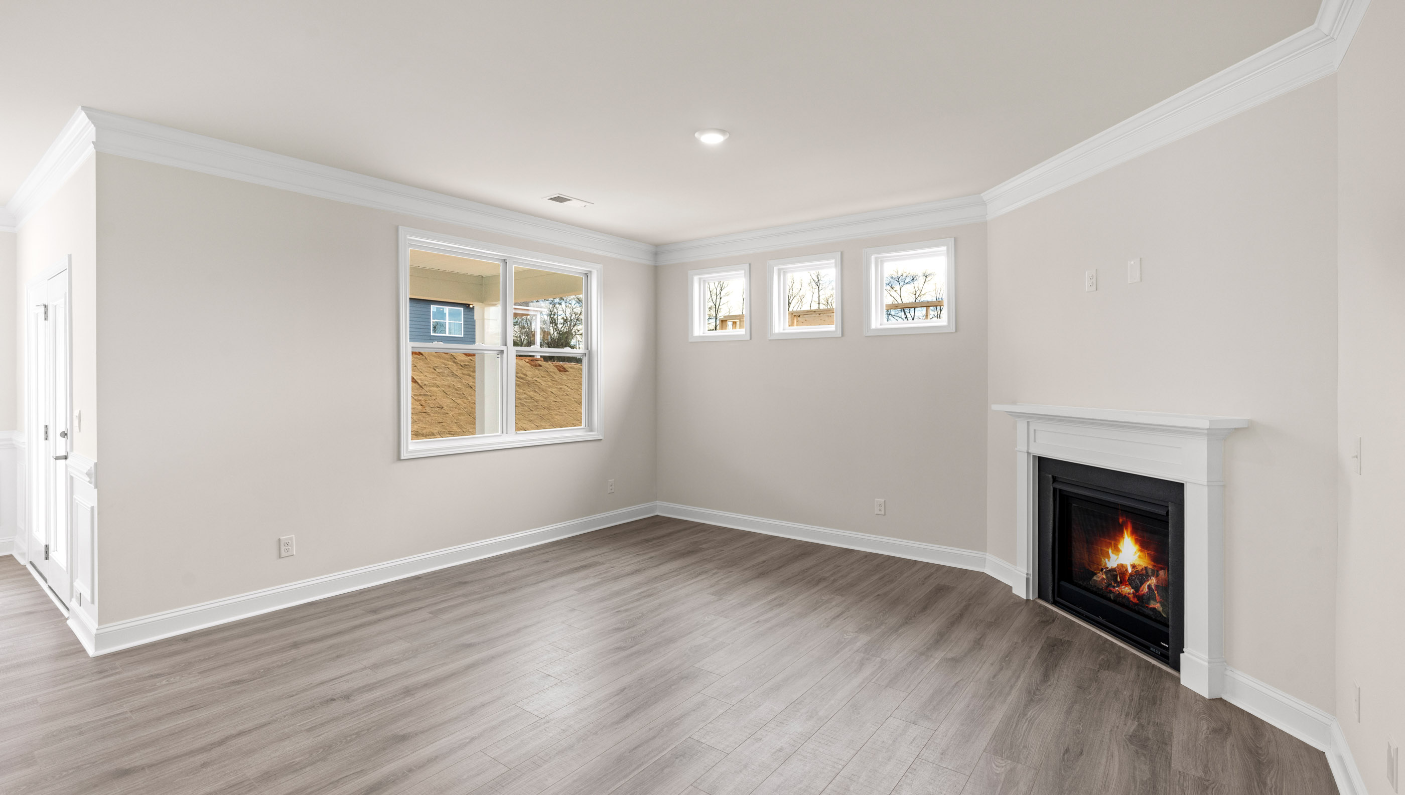 Family room with fireplace and windows.