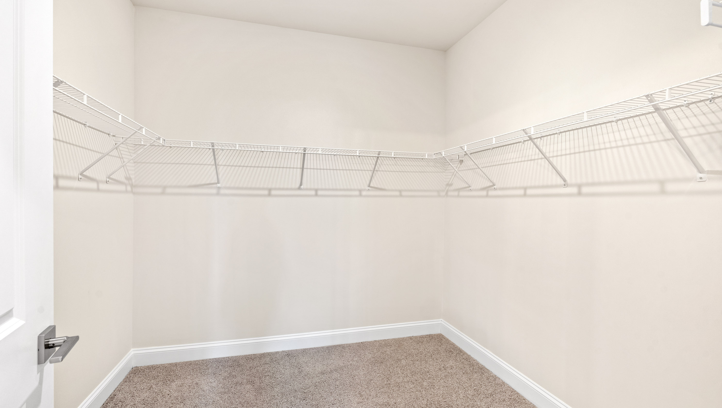 Closet with hanging storage shelves.