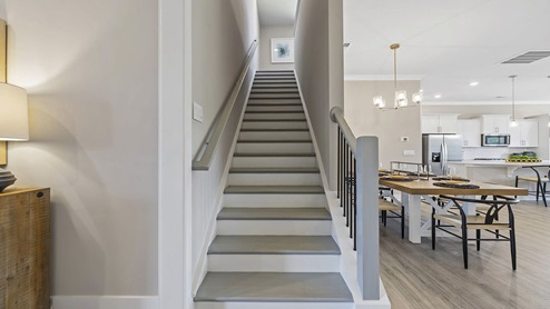 Stairs with view of kitchen.