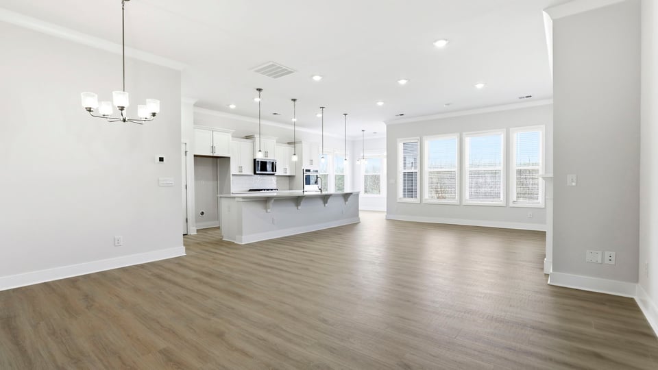 View of open floor plan with wall of windows that let in the natural sunlight.