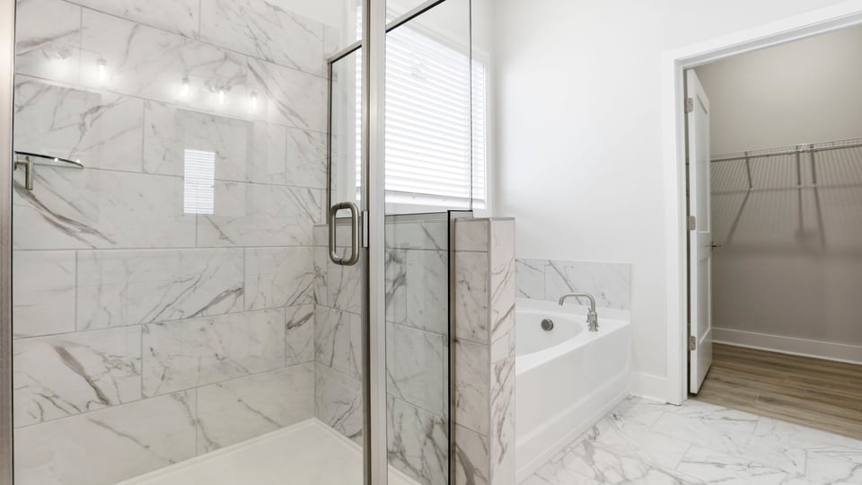 Primary bathroom with walk-in shower and garden tub.