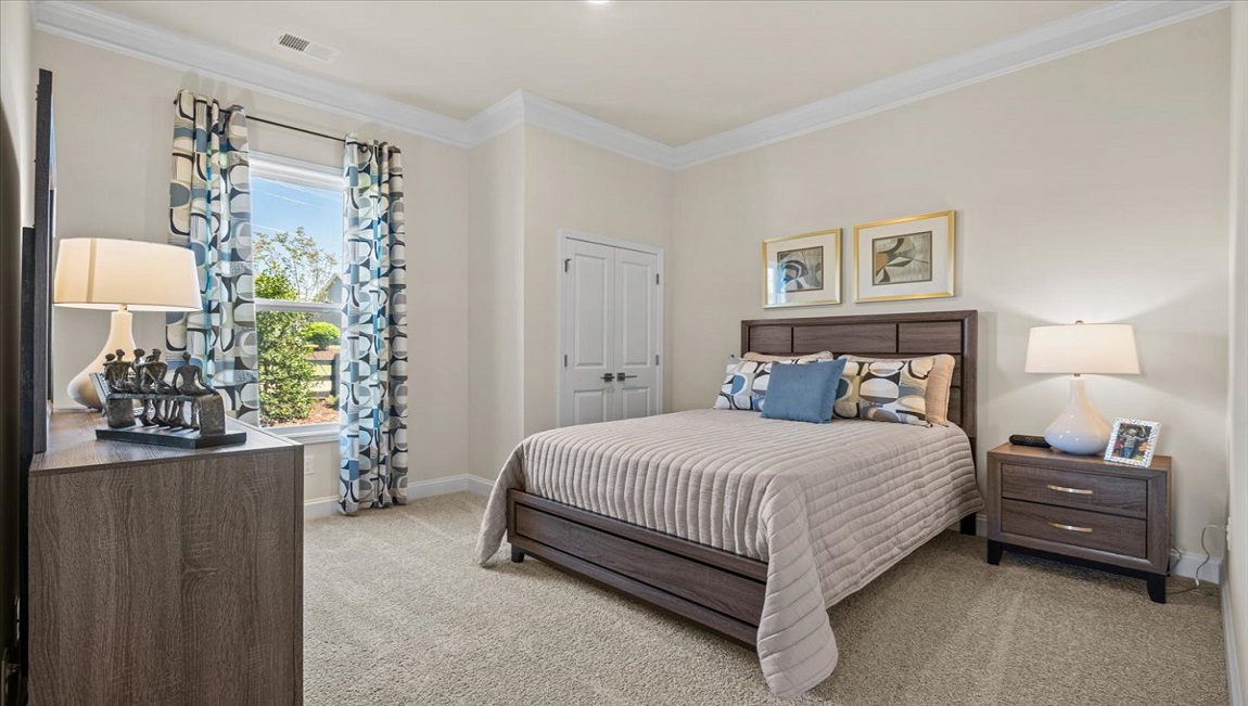 Bedroom with carpet and windows.