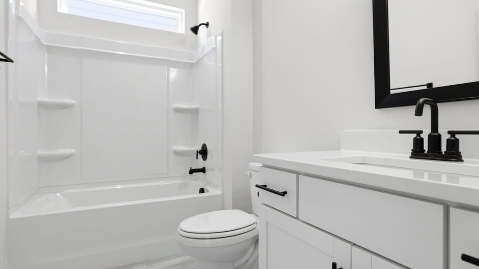 Hall bathroom with vanity and combination shower / tub.