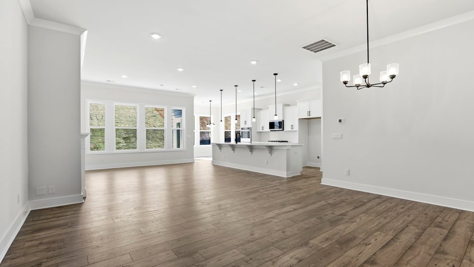 View of open floor plan with wall of windows that let in the natural sunlight.