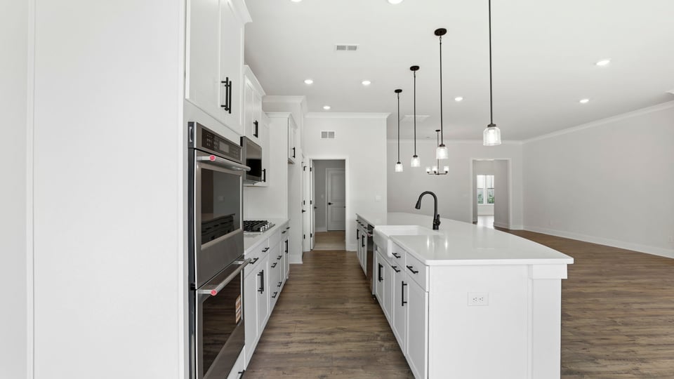 Kitchen features stainless steel appliances: gas stovetop, built in microwave and double wall ovens.