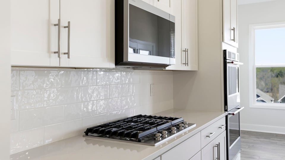 Kitchen features stainless steel appliances; gas stovetop, built in microwave and double wall ovens.