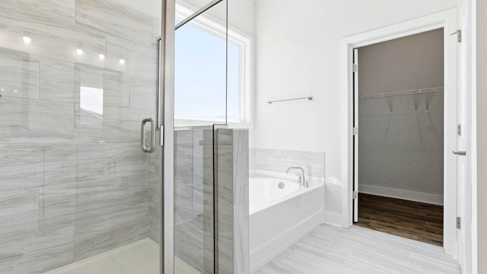 Primary bathroom with walk-in shower and garden tub.
