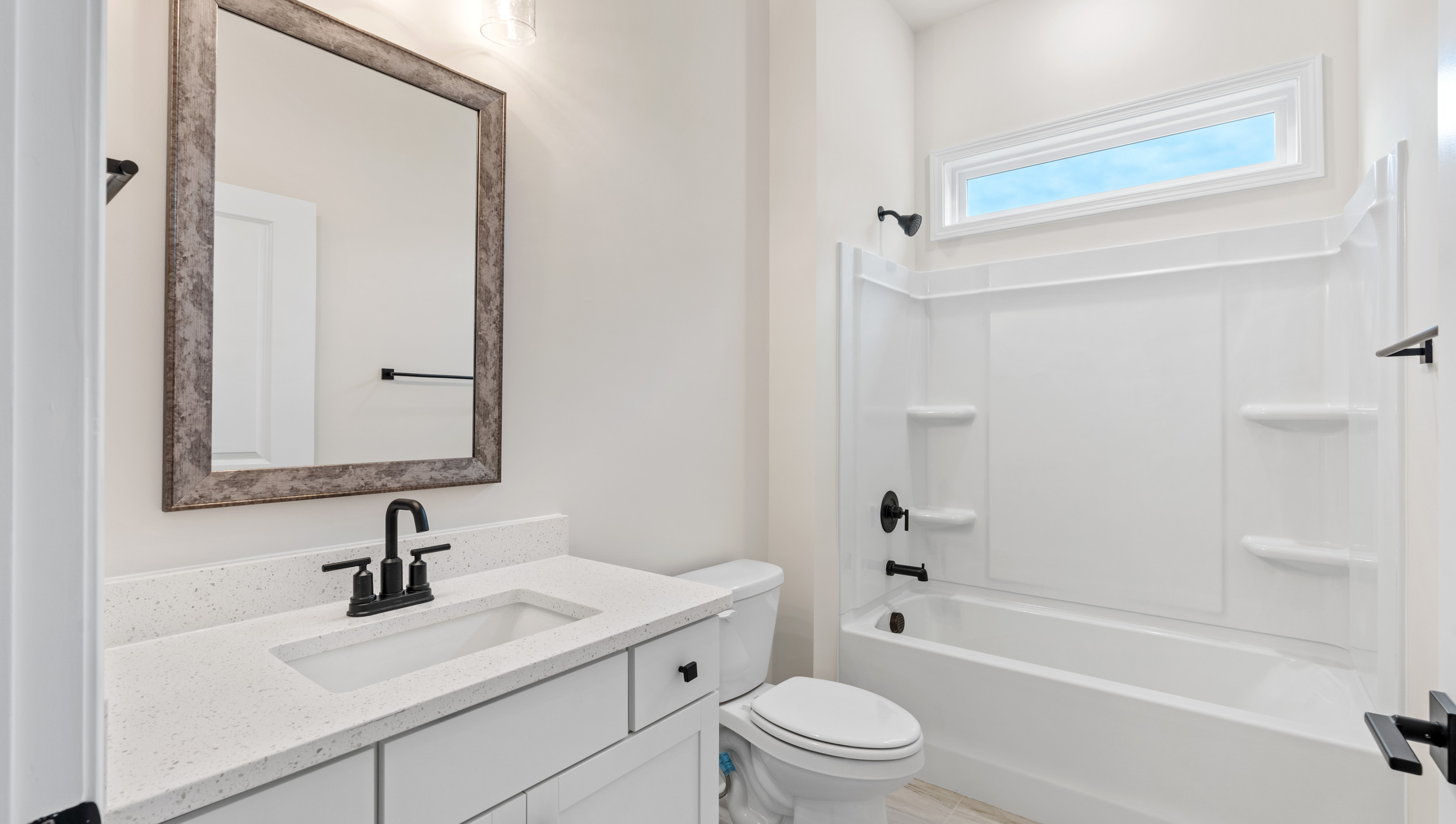 Bathroom with single vanity sink and tub.