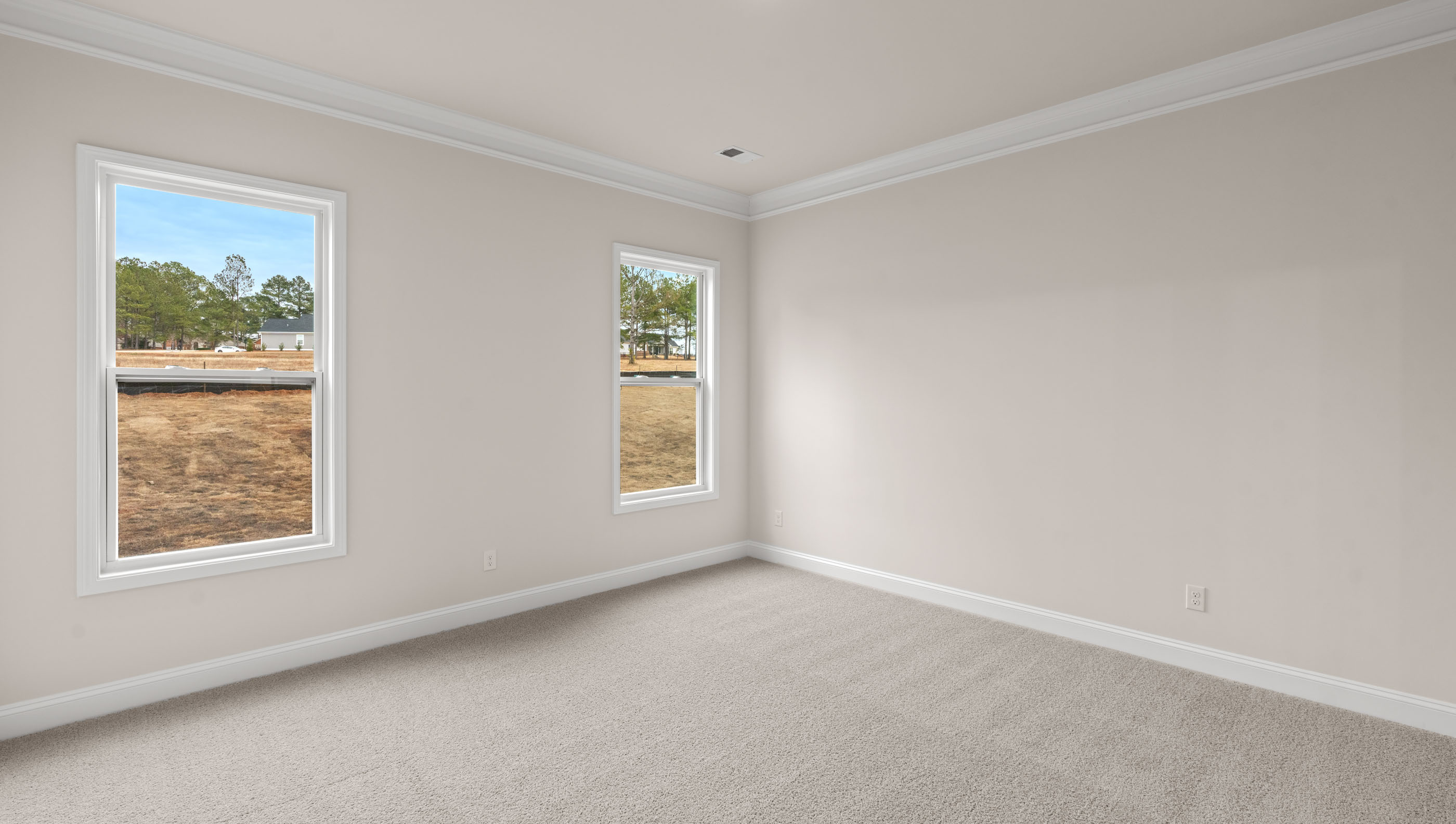 Family room with carpet and windows.