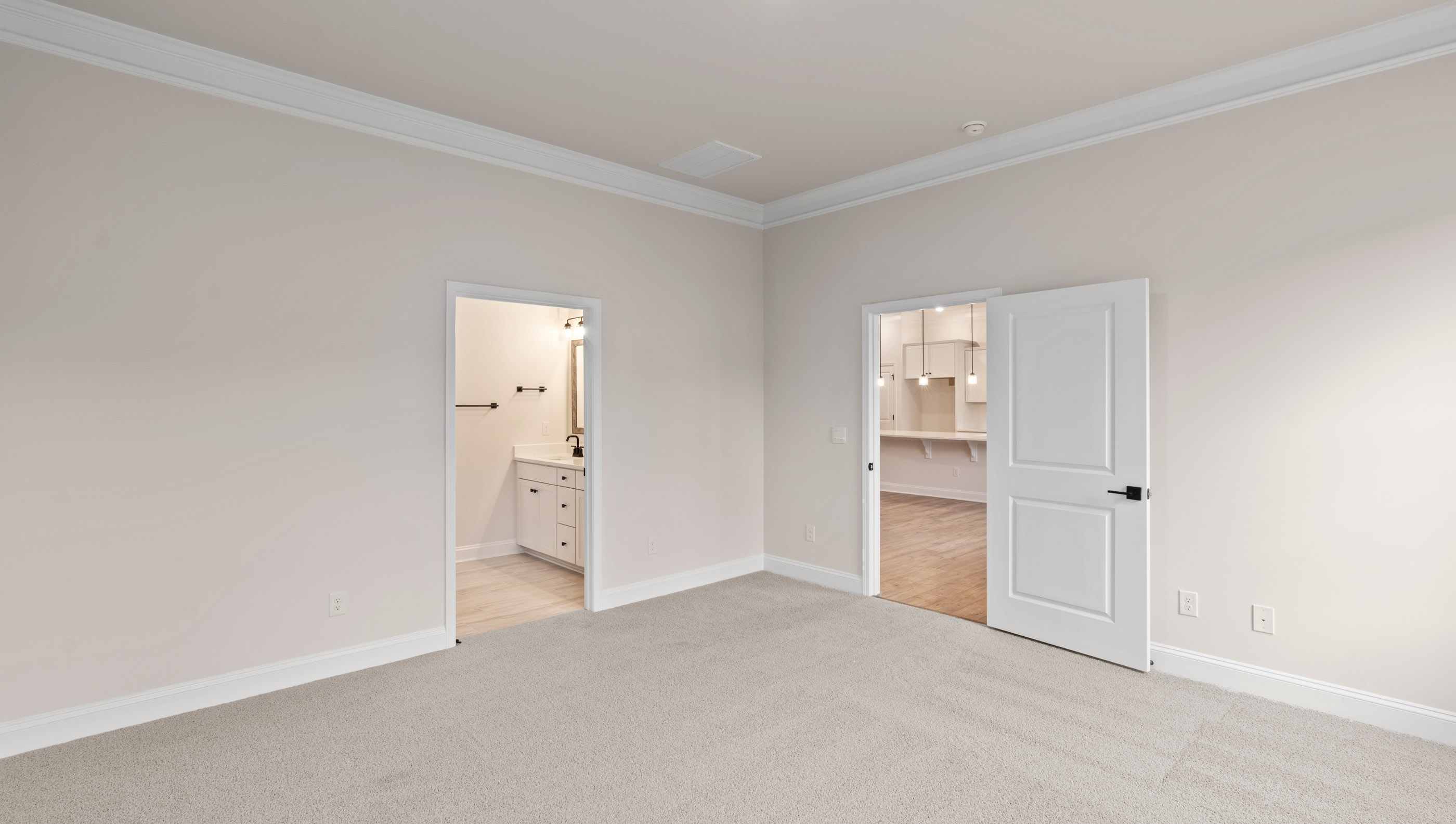 Family room with carpet and windows.