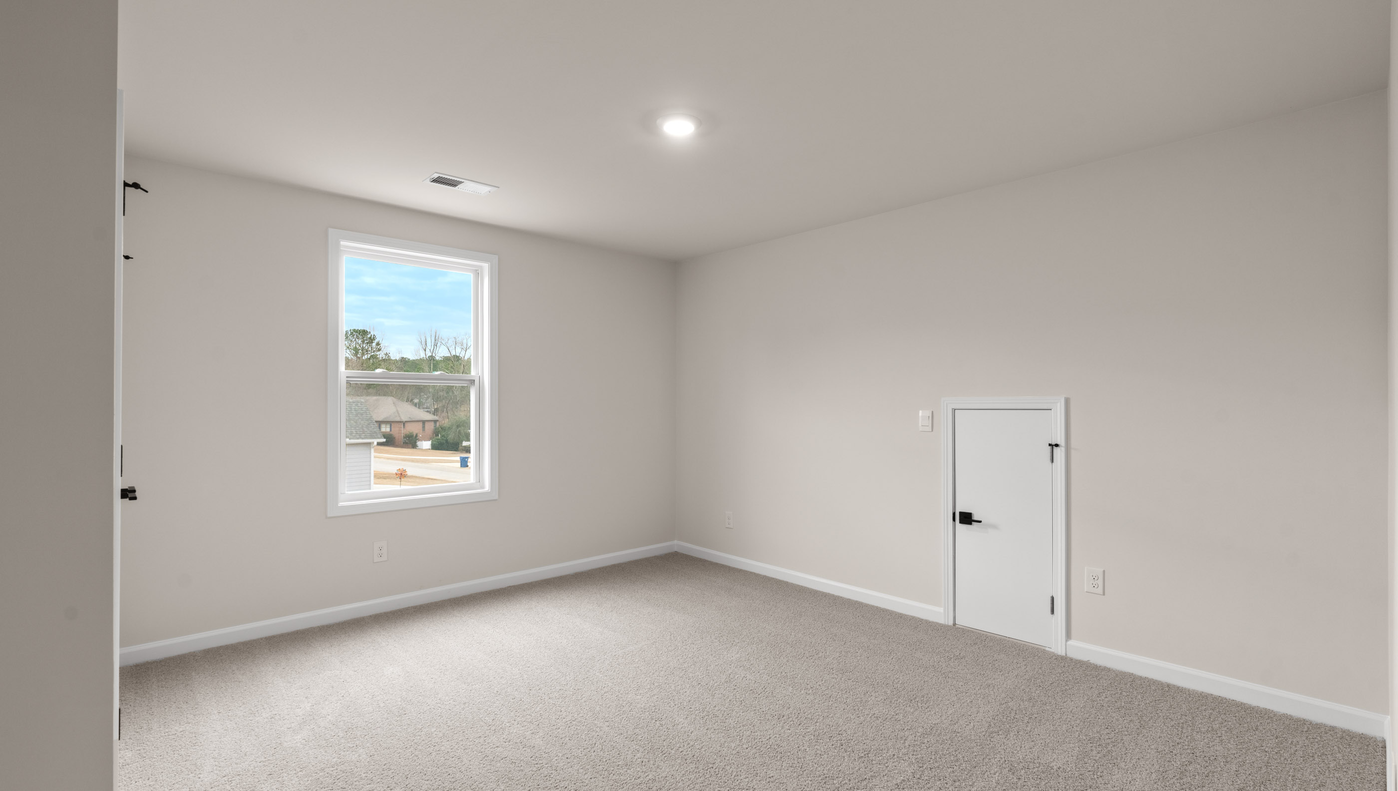 Bedroom with carpet and window.