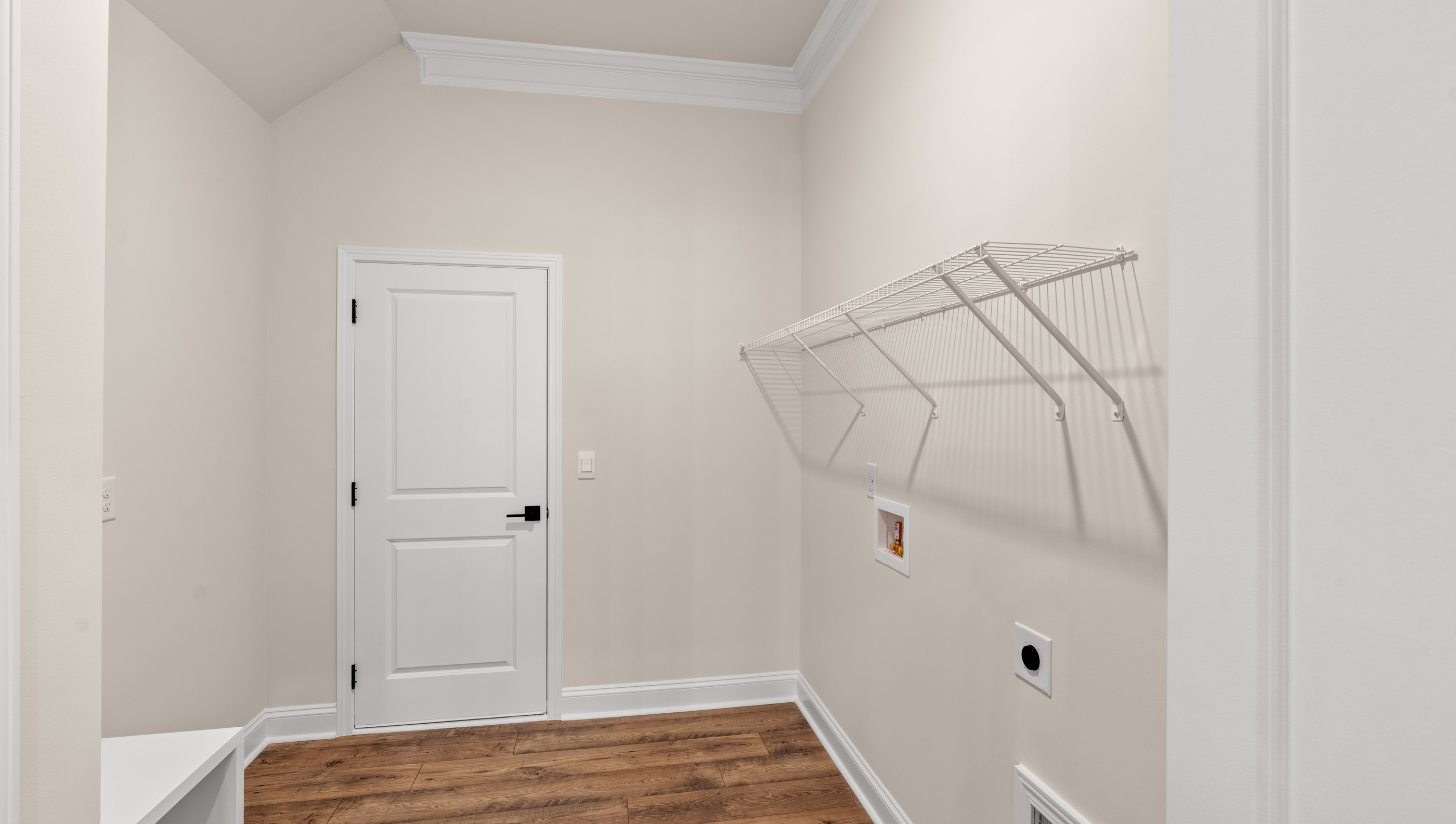Laundry room with hanging storage racks.