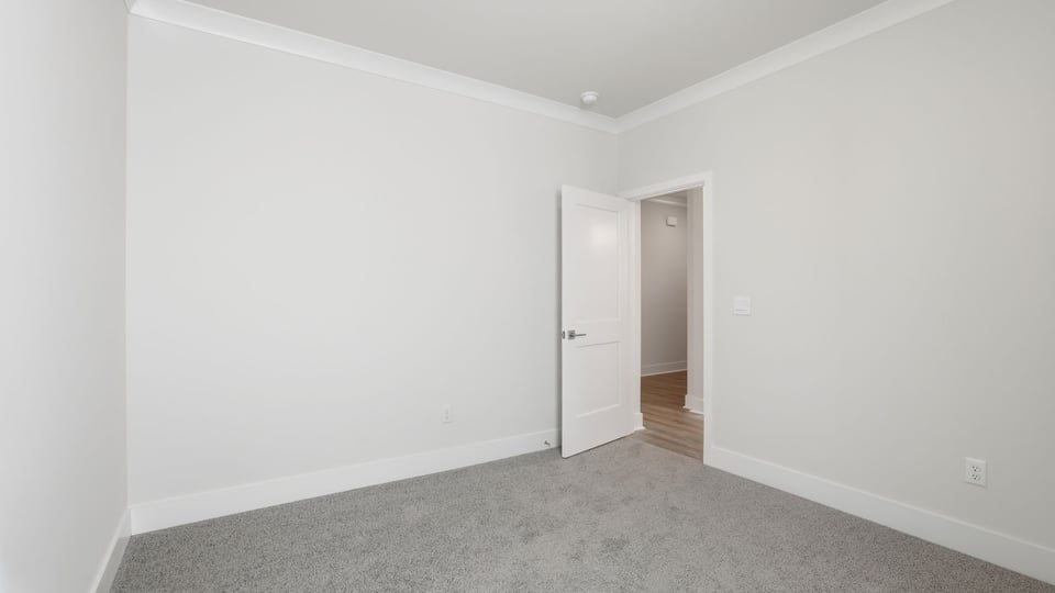 Bedroom with window and carpet.