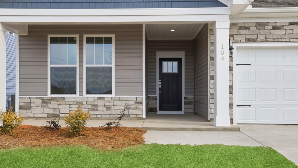 Inviting front porch with stone accents.