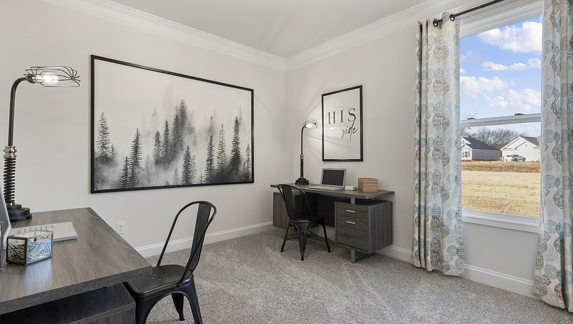 Bedroom with carpet and windows.